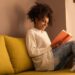 How to Tell if You Need More Insulation - smiling woman reading a book on couch